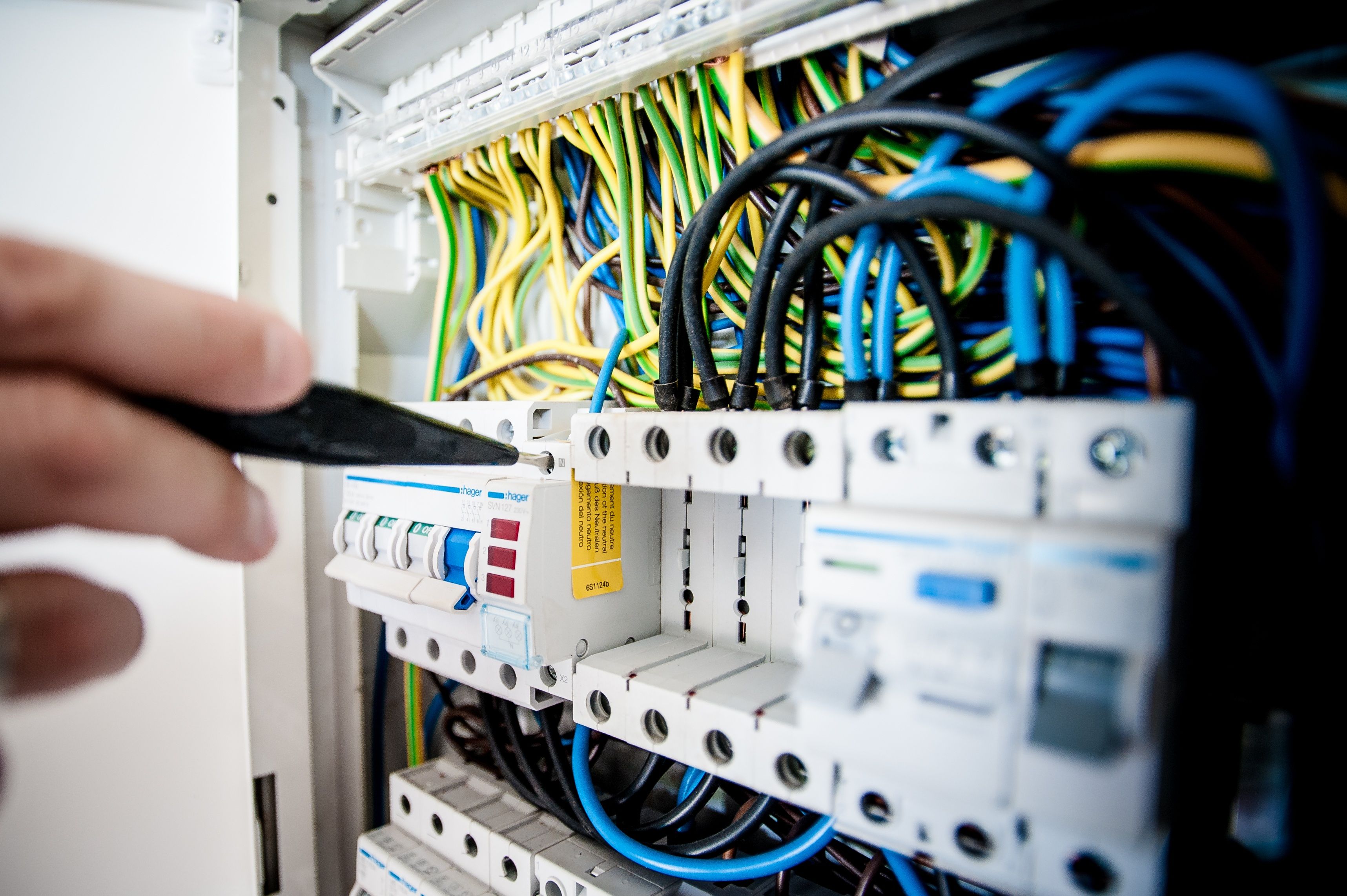Professional electrician working on electrical panel